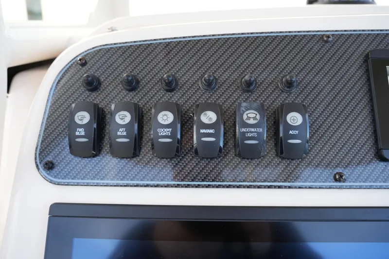 Slide: The Image of Control panel of 2026 Grady-White 251 Coastal Explorer with various switches. - 27