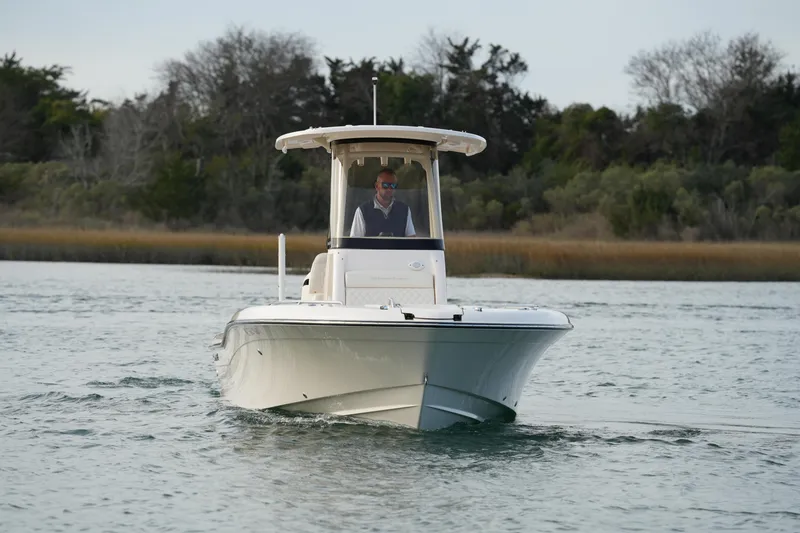 Slide: The Image of 2026 Grady-White 251 Coastal Explorer boat cruising on calm water. - 3