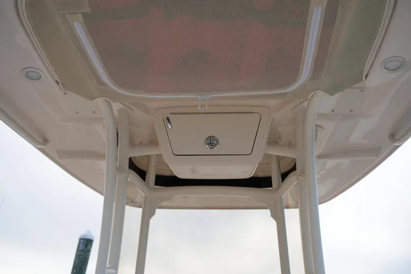 Slide: The Image of 2026 Grady-White 251 Coastal Explorer boat's overhead storage compartment and canopy. - 33