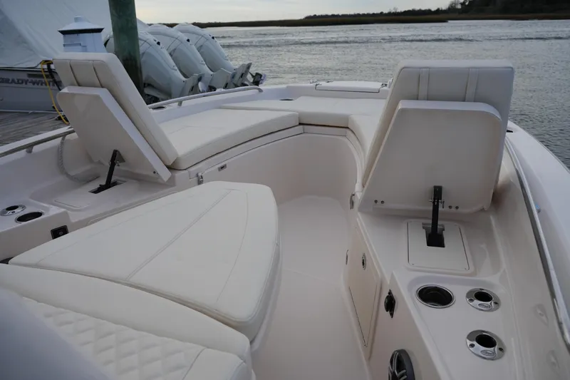 Slide: The Image of 2026 Grady-White 251 Coastal Explorer boat interior with cushioned seating and cup holders. - 37