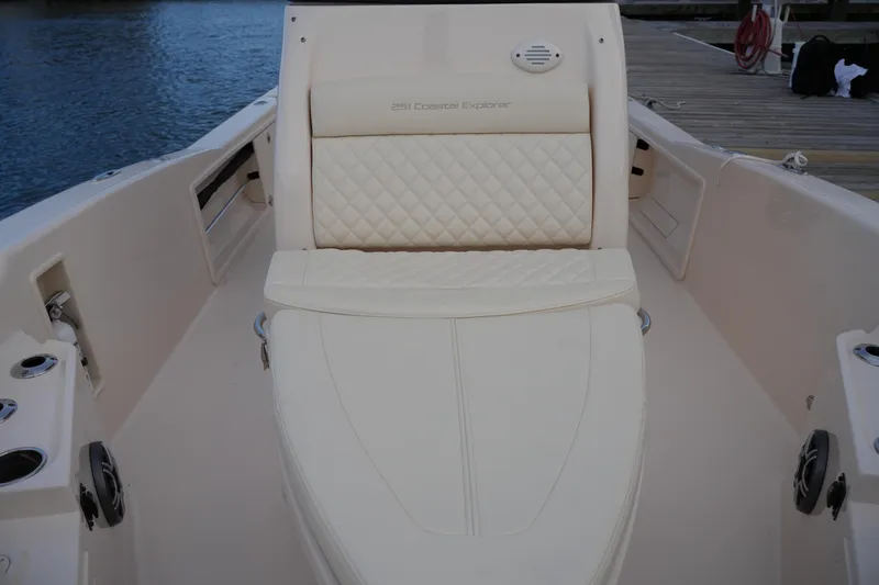 Slide: The Image of 2026 Grady-White 251 Coastal Explorer boat interior with cushioned seating and speaker. - 38