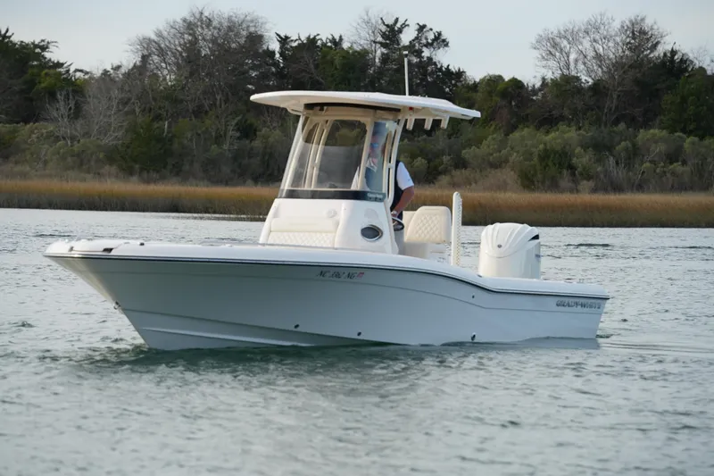 Slide: The Image of 2026 Grady-White 251 Coastal Explorer boat cruising on calm waters. - 5