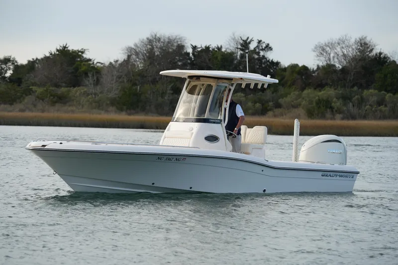 Slide: The Image of 2026 Grady-White 251 Coastal Explorer boat cruising on calm water. - 6