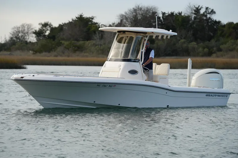 Slide: The Image of 2026 Grady-White 251 Coastal Explorer boat cruising on calm waters. - 8