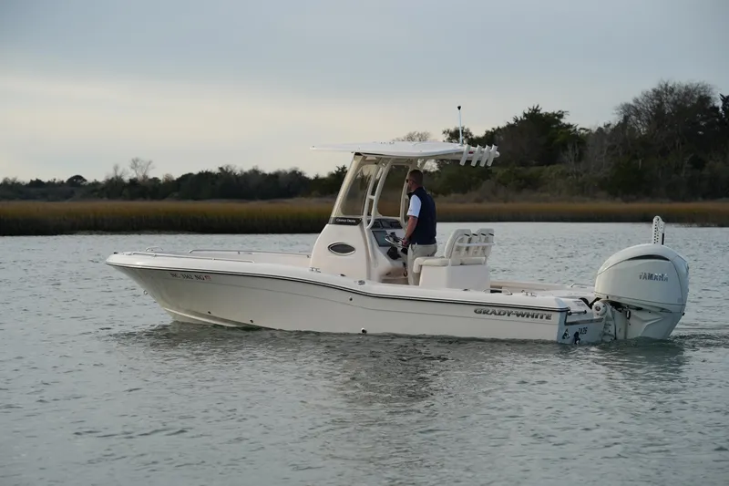 Slide: The Image of 2026 Grady-White 251 Coastal Explorer boat cruising on calm waters. - 9