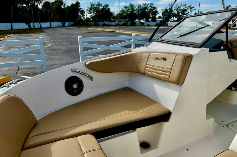 Slide: The Image of 2022 Sea Ray SPX 210 Outboard boat interior with tan seating and speaker. - 10