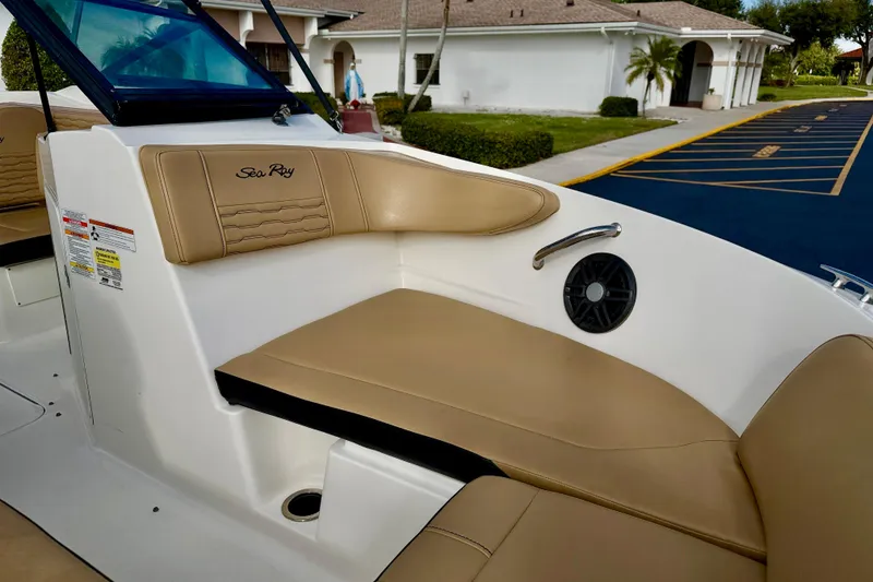 Slide: The Image of 2022 Sea Ray SPX 210 Outboard boat interior with tan seating and speaker. - 11