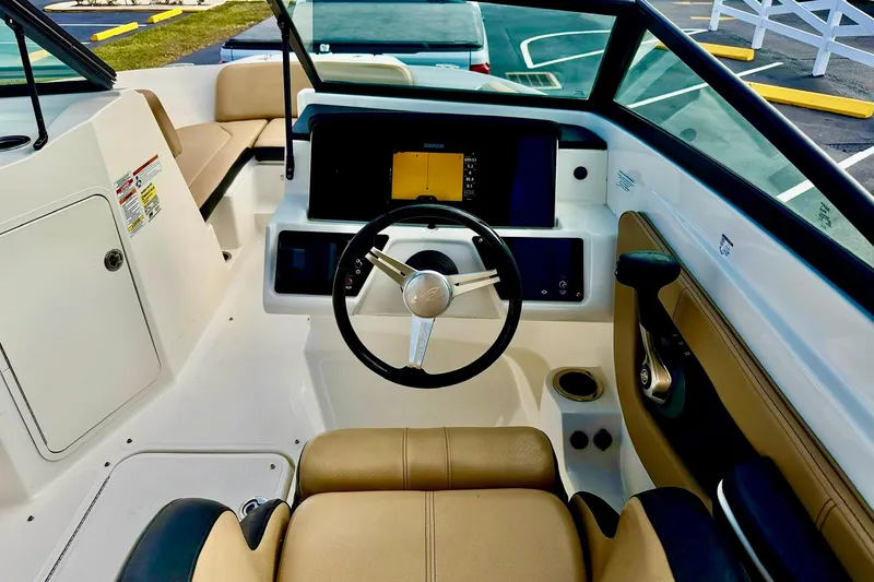Slide: The Image of 2022 Sea Ray SPX 210 Outboard boat interior with steering wheel and dashboard. - 12