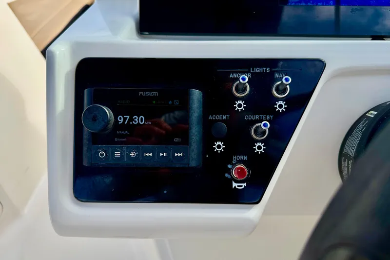 Slide: The Image of Control panel of 2022 Sea Ray SPX 210 Outboard with radio and light switches. - 15