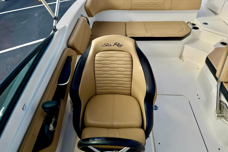 Slide: The Image of 2022 Sea Ray SPX 210 Outboard interior with tan and black seating. - 19