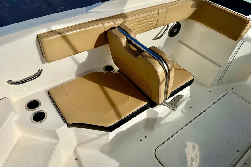 Slide: The Image of 2022 Sea Ray SPX 210 Outboard interior with tan seating and cup holders. - 22
