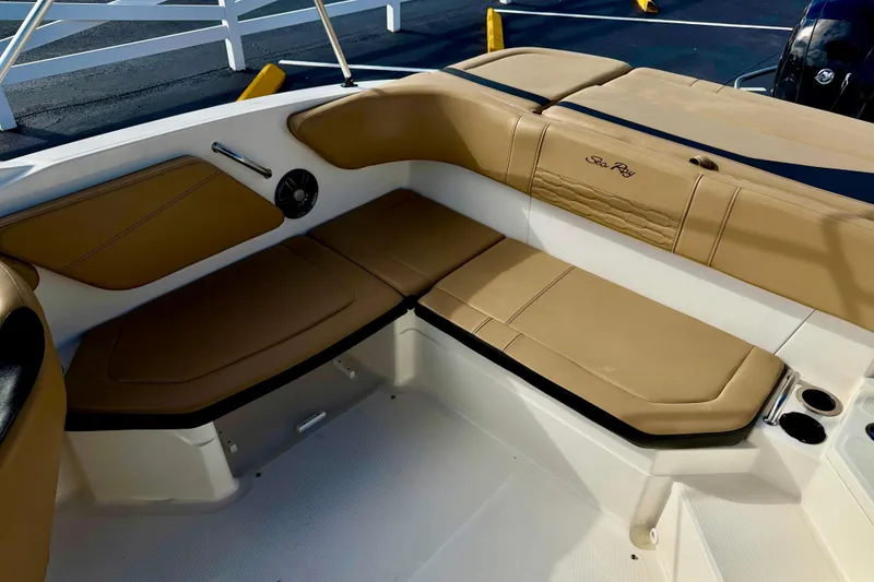 Slide: The Image of 2022 Sea Ray SPX 210 Outboard boat interior with tan seating and cup holders. - 23