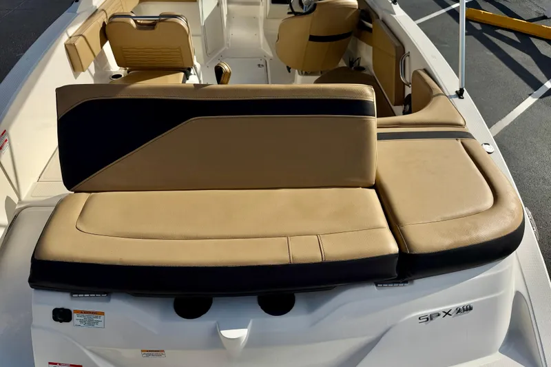 Slide: The Image of 2022 Sea Ray SPX 210 Outboard boat interior with tan and black seating. - 26
