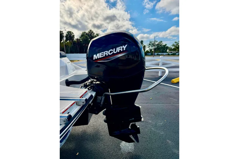 Slide: The Image of 2022 Sea Ray SPX 210 Outboard with Mercury engine, parked outdoors under a cloudy sky. - 27