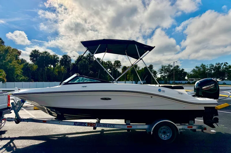 Slide: The Image of 2022 Sea Ray SPX 210 Outboard boat on trailer under a cloudy sky. - 3