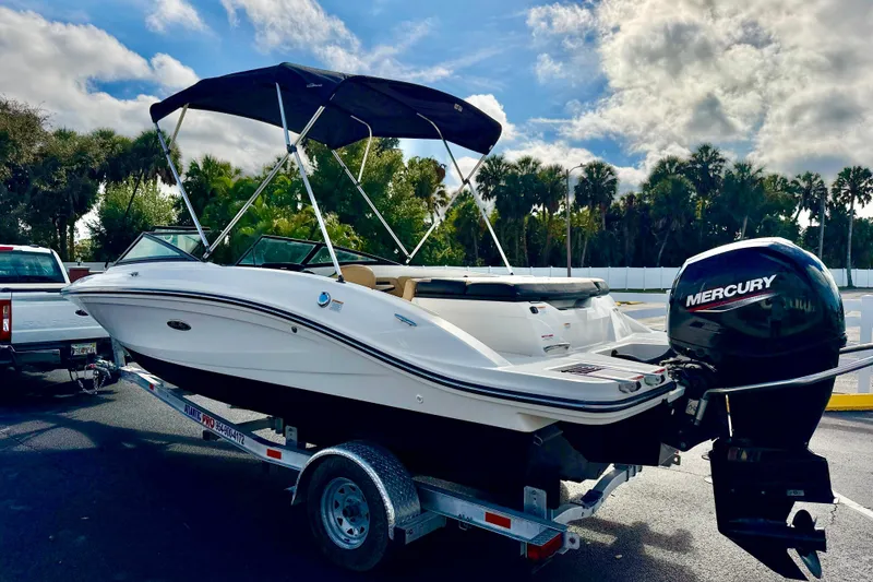 Slide: The Image of 2022 Sea Ray SPX 210 Outboard boat on trailer, featuring a Mercury engine. - 6