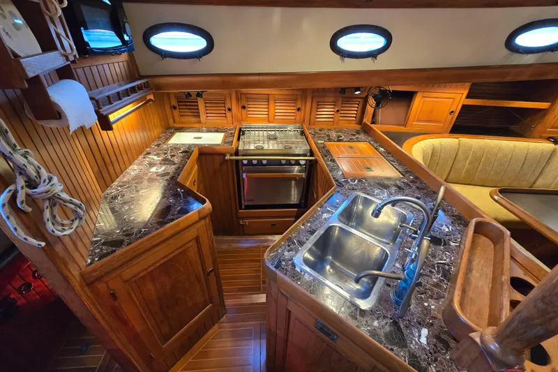 Slide: The Image of Luxurious 1986 Hans Christian 38T yacht kitchen with marble countertops and wooden cabinetry. - 20