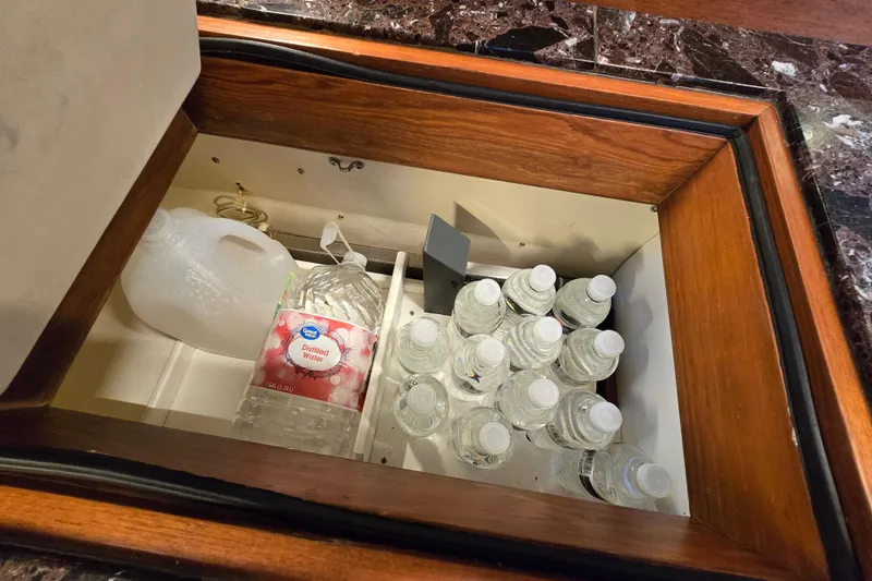 Slide: The Image of Hidden compartment with water bottles and jug on a Hans Christian 38T, 1986 model. - 24