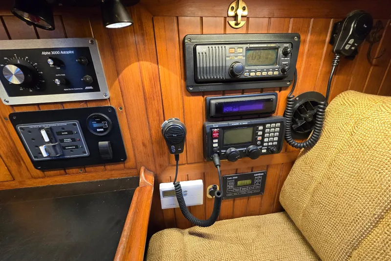 Slide: The Image of 1986 Hans Christian 38T yacht navigation panel with communication and control equipment. - 27