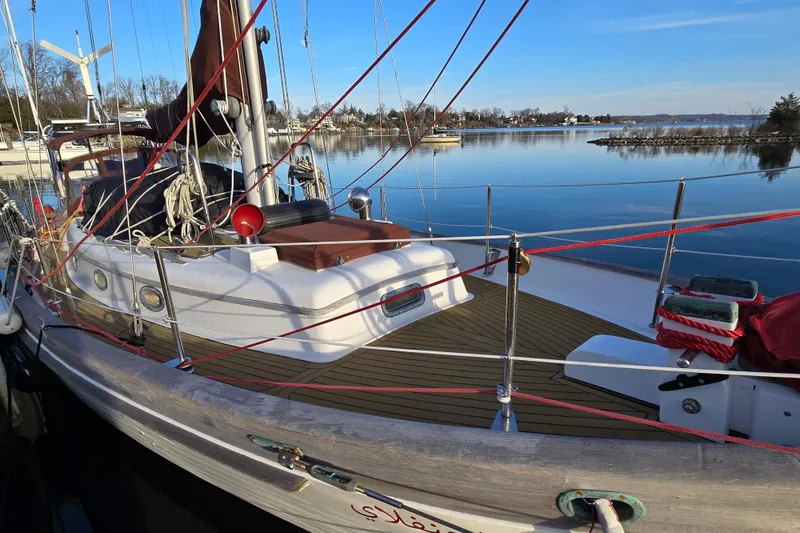 Slide: The Image of 1986 Hans Christian 38T sailboat docked on calm water, showcasing deck and rigging. - 3