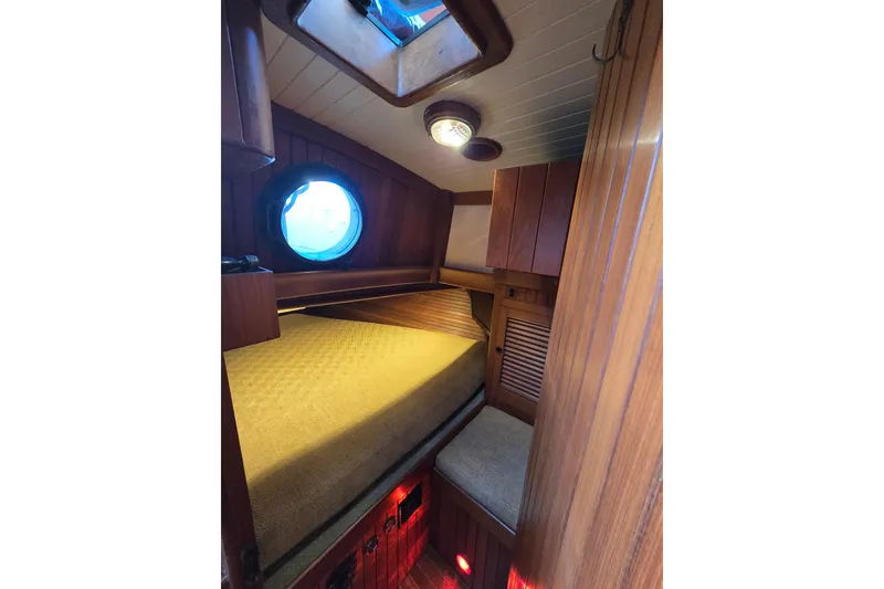 Slide: The Image of Cozy cabin interior of 1986 Hans Christian 38T sailboat with wooden finish and porthole. - 33