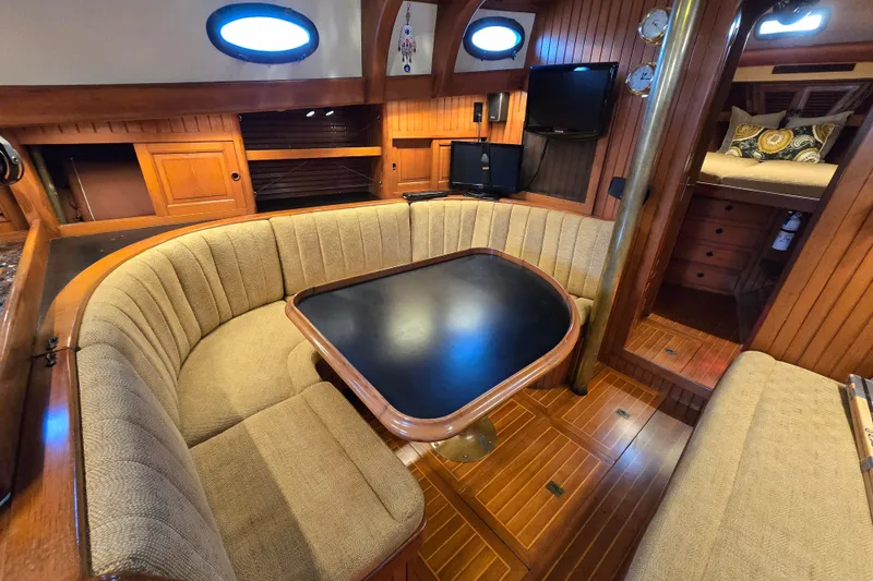 Slide: The Image of Interior of 1986 Hans Christian 38T sailboat with cozy dining area and wood paneling. - 35