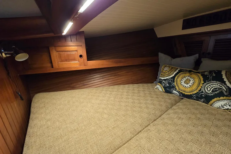 Slide: The Image of Cozy cabin interior of 1986 Hans Christian 38T sailboat with wooden accents and patterned pillow. - 39