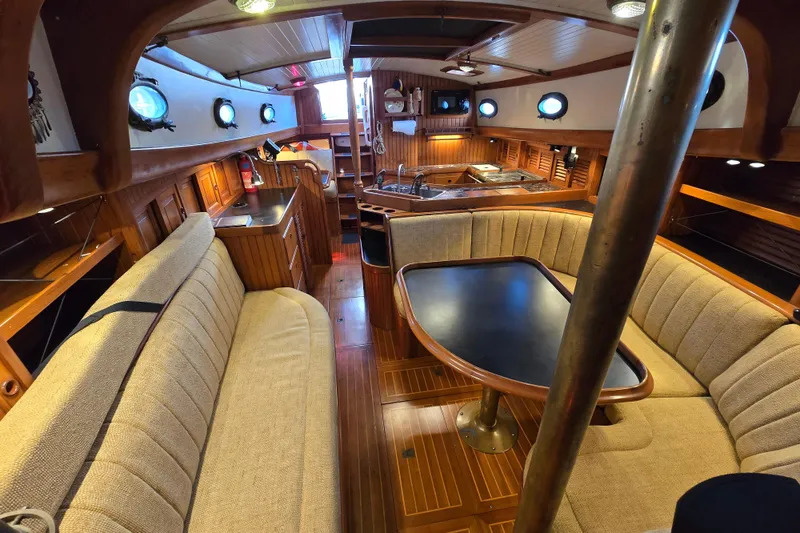 Slide: The Image of Interior of 1986 Hans Christian 38T sailboat with wooden furnishings and cozy seating area. - 4