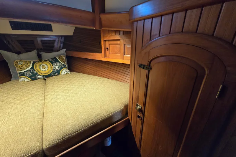 Slide: The Image of Cozy cabin interior of 1986 Hans Christian 38T sailboat with wooden finish and decorative pillows. - 40