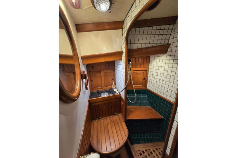 Slide: The Image of 1986 Hans Christian 38T yacht bathroom with wooden accents and tiled shower area. - 41