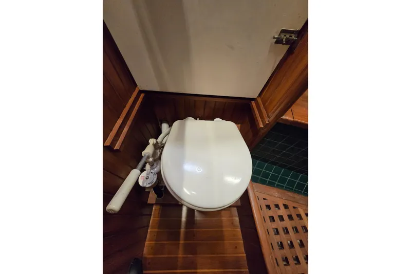 Slide: The Image of Wooden boat bathroom with white toilet seat, Hans Christian 38T, 1986 model. - 42