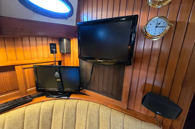Slide: The Image of Interior of 1986 Hans Christian 38T yacht with wood paneling, TV, and clock. - 44