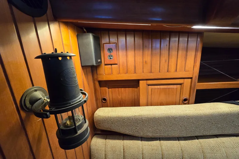 Slide: The Image of 1986 Hans Christian 38T interior with vintage lantern and wooden paneling. - 45