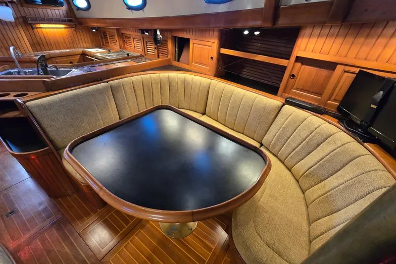 Slide: The Image of 1986 Hans Christian 38T yacht interior with cozy dining area and wooden accents. - 46