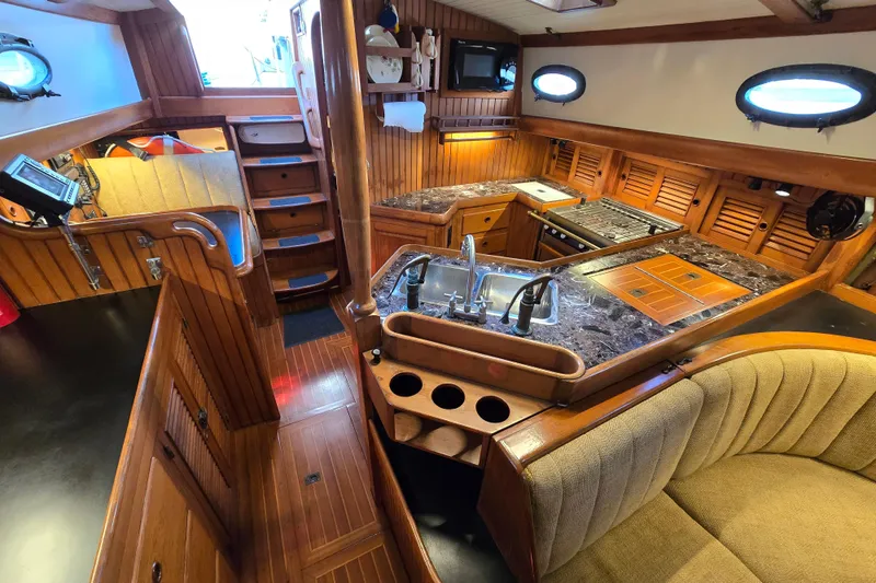 Slide: The Image of 1986 Hans Christian 38T yacht interior with wooden cabinetry and modern kitchen amenities. - 47