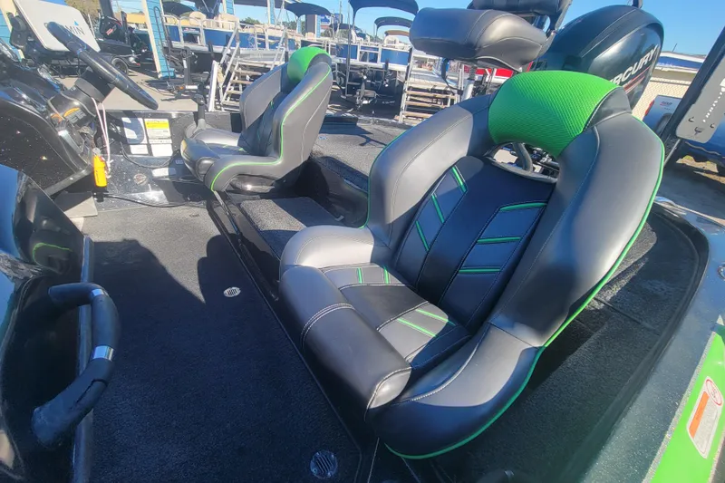 Slide: The Image of 2018 Nitro Z18 boat interior with green-accented seats and steering console. - 13