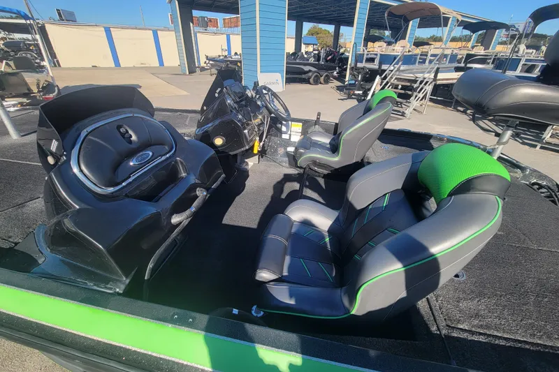 Slide: The Image of 2018 Nitro Z18 boat interior with green-accented seats at a marina. - 8