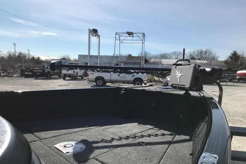 Slide: The Image of 2026 Lund 1775 Impact XS Sport boat with advanced trolling motor in a sunny outdoor setting. - 12