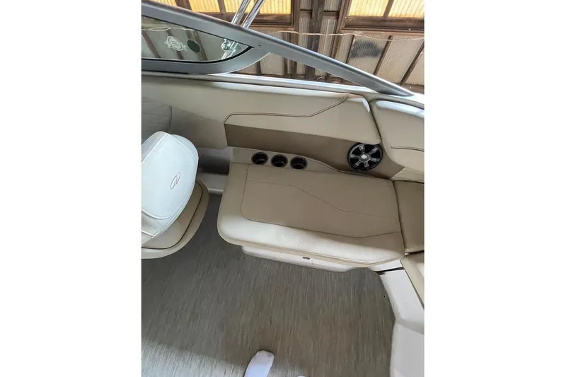 Slide: The Image of 2019 Regal 22 FasDeck boat interior with beige seating and spacious layout. - 16