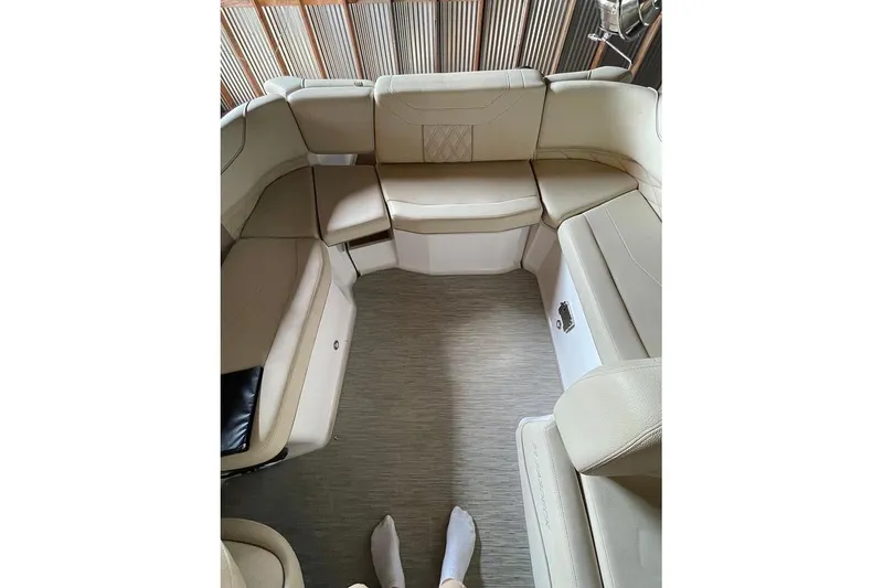 Slide: The Image of 2019 Regal 22 FasDeck interior with beige seating and speaker system. - 18