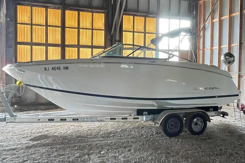 Slide: The Image of 2019 Regal 22 FasDeck boat in storage, front view with trailer. - 2