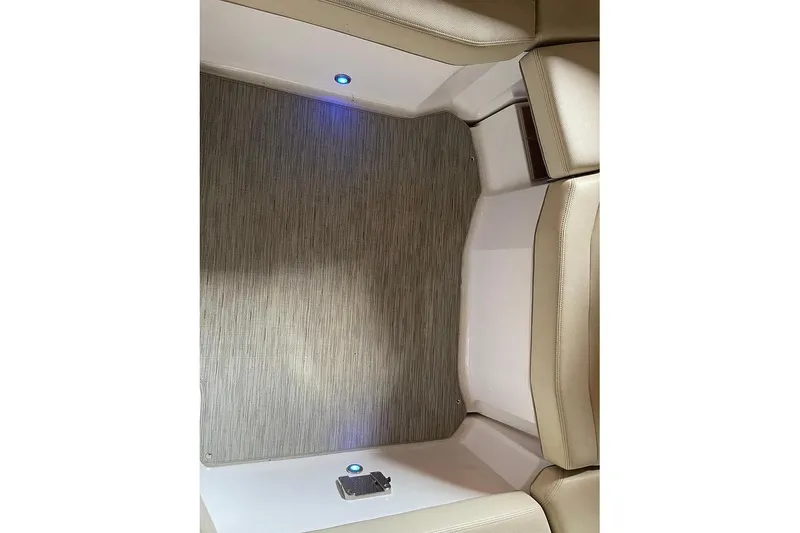 Slide: The Image of Interior of 2019 Regal 22 FasDeck boat with beige seating and wood accents. - 20