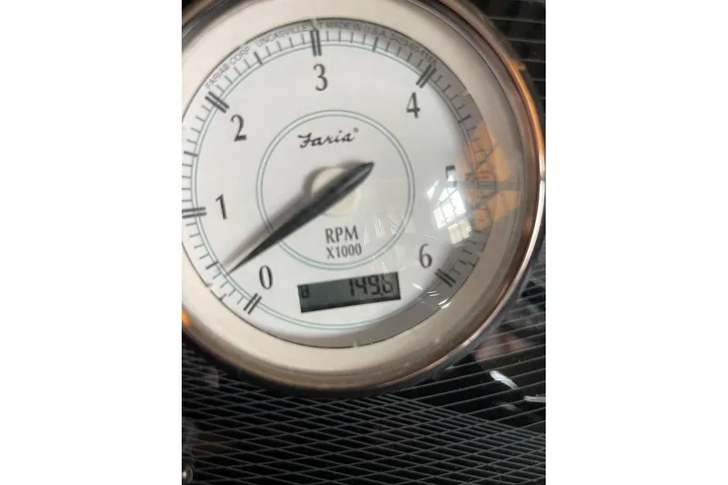 Slide: The Image of 2019 Regal 22 FasDeck interior with beige seating and blue LED floor lights. - 22