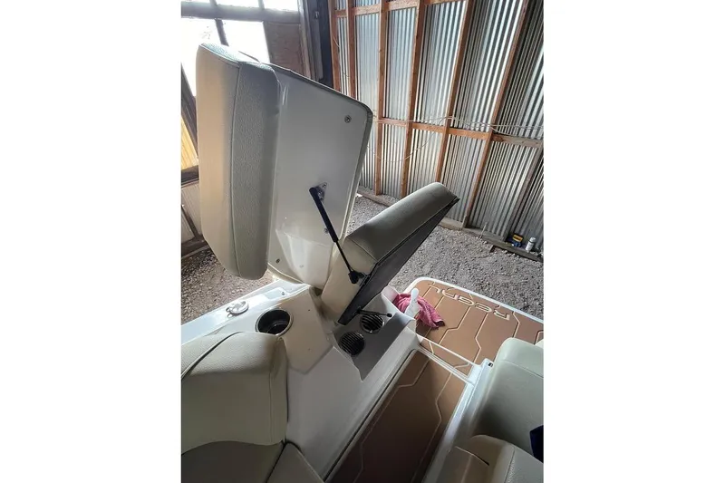 Slide: The Image of Interior of 2019 Regal 22 FasDeck boat with beige seating and blue LED lights. - 23