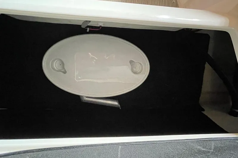 Slide: The Image of 2019 Regal 22 FasDeck boat interior with beige seating and brown flooring. - 26