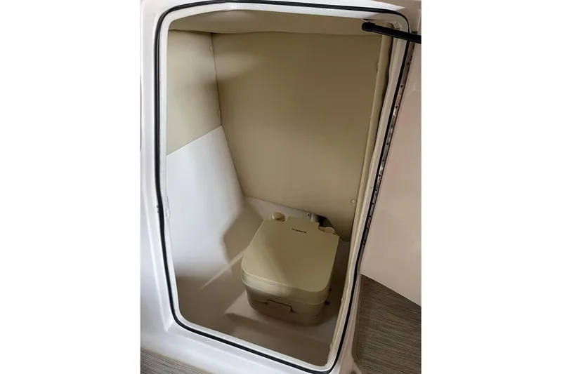 Slide: The Image of 2019 Regal 22 FasDeck interior with beige seating and integrated speakers. - 30