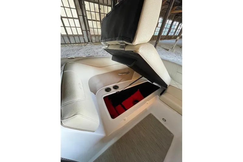 Slide: The Image of 2019 Regal 22 FasDeck boat interior in a rustic warehouse setting. - 37