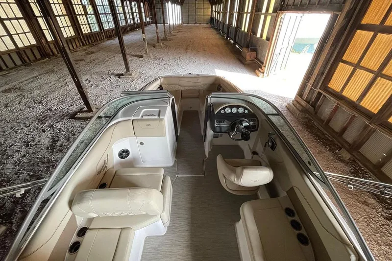Slide: The Image of 2019 Regal 22 FasDeck boat with beige interior, stored in a metal shed. - 42
