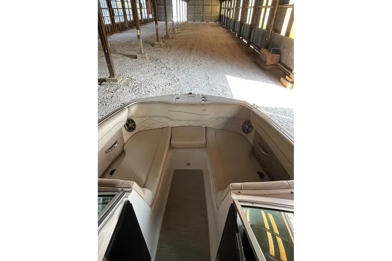 Slide: The Image of 2019 Regal 22 FasDeck boat interior in a spacious warehouse setting. - 44