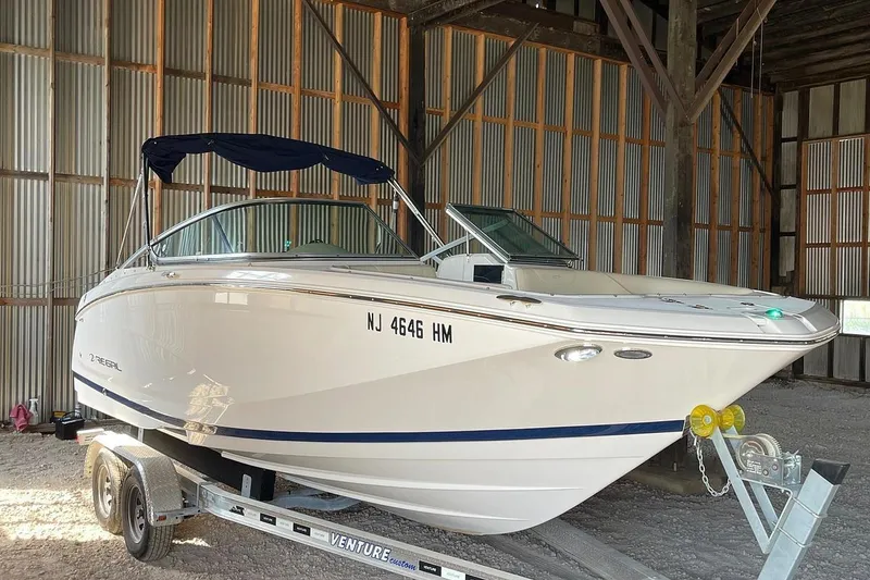 Slide: The Image of 2019 Regal 22 FasDeck boat on trailer in storage facility. - 52